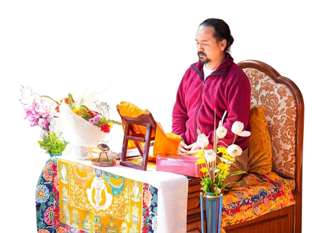 Chogyal Rinpoche sitting inside with flowers